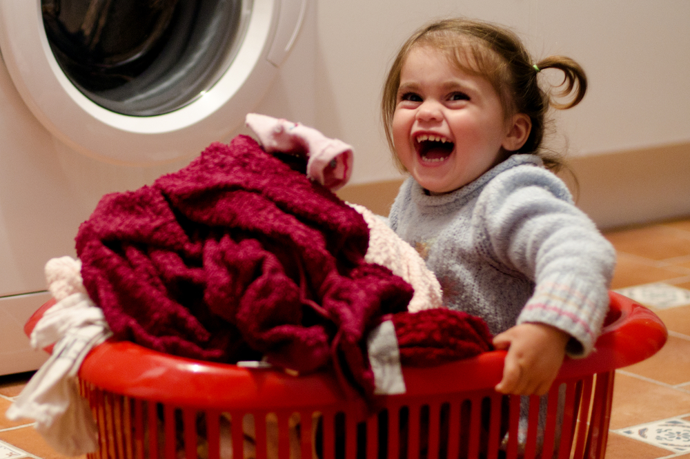 child in a laundry basket