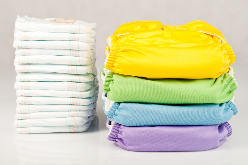 pile of cloth and disposable diapers - cloth diapers vs disposable diapers