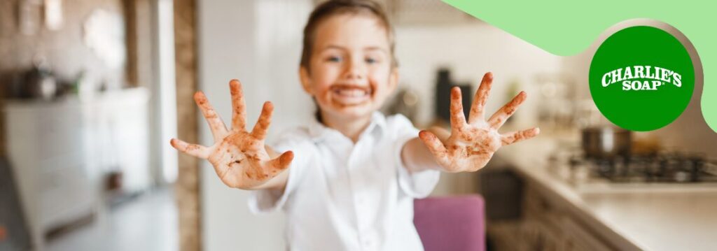 Kid with chocolate stained hands.